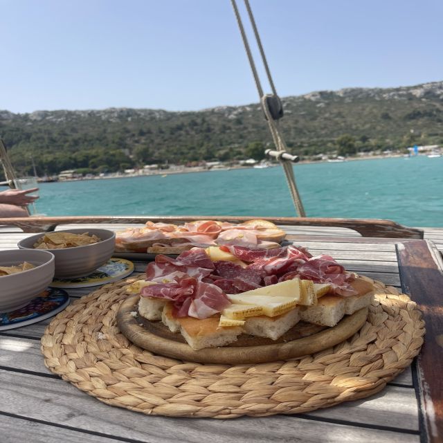 Cagliari: Boat Tour with Swim Stops, Snorkeling, & Aperitif - Boarding at Marina Piccola and settling into the gozzo