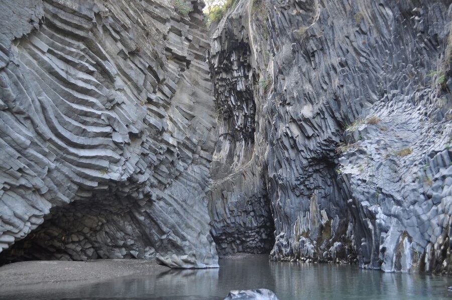 From Catania: Mt. Etna, Wine and Alcantara Tour - Entering an Etna lava cave with a helmet and lamp