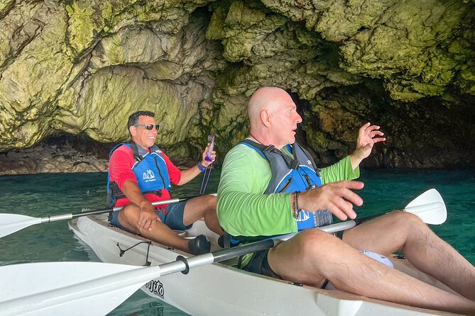 Kayak tour in Capri between caves and beaches. Photos included. - Swimming below the caves and near the Faraglioni